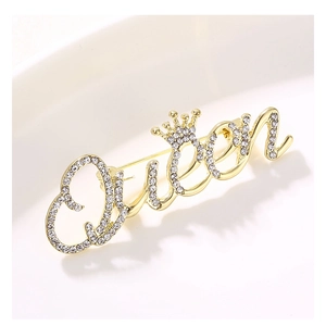Detailed macro view of a gold-toned Queen brooch with sparkling crystal rhinestones