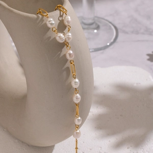 Detailed macro of baroque freshwater pearls and 18K gold plated stainless steel chain