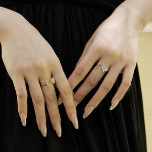 Close-up of gold and silver S925 sterling silver rings with T-shape heart zircon details