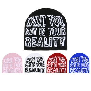 Detail of the knit beanie showing the jacquard lettering and soft fabric textures