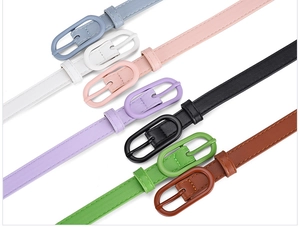 Close-up of colorful faux leather belts with matching oval buckles in macaron tones