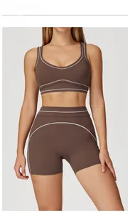 Detail of high-waisted yoga shorts in deep chocolate brown with white contrast stitching