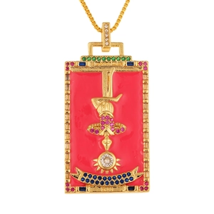 Macro detail of a golden tarot card pendant with red enamel, gems, and XIII engraving