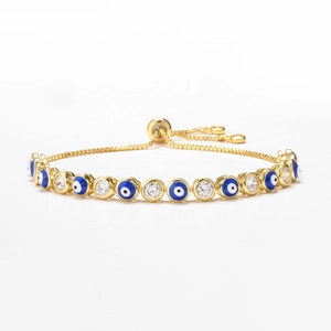 Detail of adjustable gold evil eye bracelet with blue enamel beads and cubic zirconia