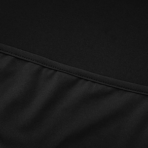 Detailed close-up of fine stitching and black elastic fabric on a slim-fit dress