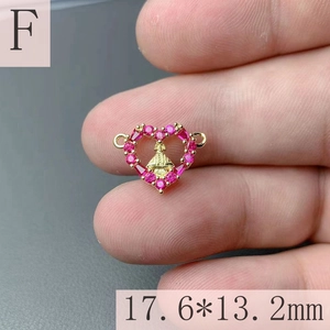 Macro shot showing 17.6x13.2mm gold heart pendant with pink zircon and holy icon