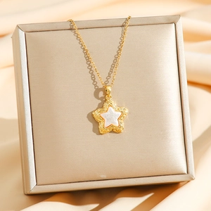 Golden necklace featuring a star pendant with mother-of-pearl inlay and textured edges