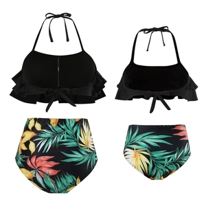 Front and back view of matching black ruffled bikini sets with tropical leaf print bottoms
