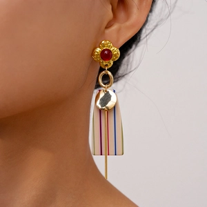 Detailed close-up of retro floral resin earrings with colorful stripes on female model