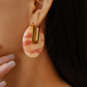 Detailed close-up of pink marble acetate earring with 18k gold plated U-shaped clasp