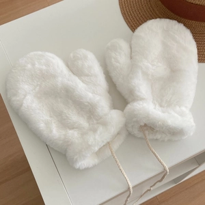 Close-up of white plush faux fur mittens with a woven neck lanyard for winter
