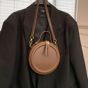 Retro brown circular crossbody bag with gold hardware and top handle for women