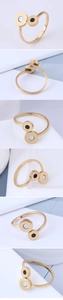 Macro detail of gold stainless steel ring with Greek key motif and dual disc inlays