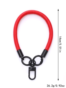 Detail showing the 14cm red leather wrist strap with black metal rings and its 26.2g weight