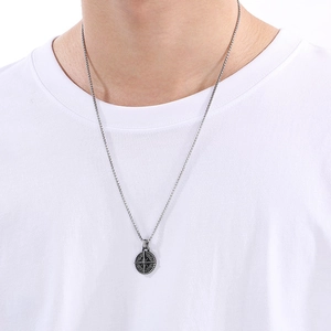 Men's silver stainless steel compass star pendant necklace on a clean white t-shirt