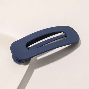 Close-up of navy blue matte rectangle hollow hair clip with elegant frosted resin finish