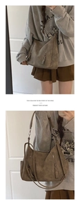 Detail of khaki suede shoulder bag featuring vertical zippers and large capacity design