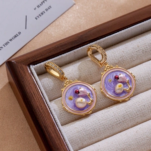 Detail of vintage purple enamel floral earrings with white pearls in a jewelry box