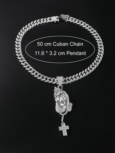 Macro shot of 50cm silver Cuban chain with a large iced-out praying hands cross pendant
