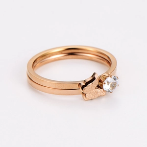 Detail of rose gold double-layer ring featuring a frosted butterfly and zircon stone