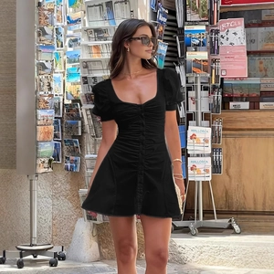 Detail of black puff sleeve mini dress with front ruching on a street scene model