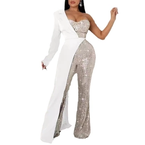 Detail of silver sequin patchwork on one-shoulder white jumpsuit for elegant party wear