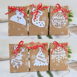 Detail view of 6 Kraft paper Christmas gift bags with various holiday cutout tags