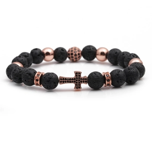 Detail of black lava stone beads and a rose gold micro-pave cross charm on the bracelet
