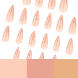 Almond-shaped pink cat-eye press-on nails with gold foil and pearl accents