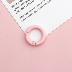 Detailed close-up of a 20mm pink painted round spring snap ring for DIY jewelry making