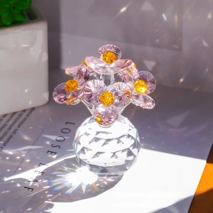 Detailed view of crystal flower with rainbow prism light reflection on glass base