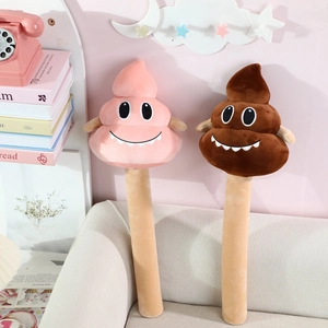 Funny plush poop hammers in pink and brown with cartoon faces on a sofa