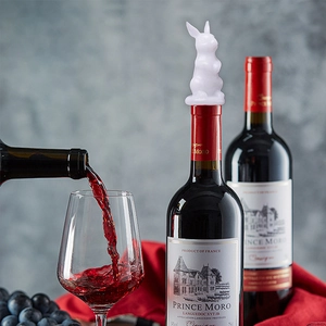 DIY silicone wine bottle stopper in white rabbit shape placed on a wine bottle neck