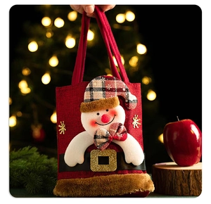 Detail of Christmas snowman candy bag with red plaid and golden snowflake embroidery