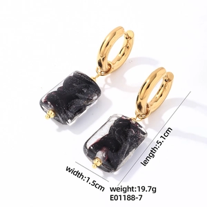 Detail view of gold hoop earrings with black rectangular natural stone and dimensions