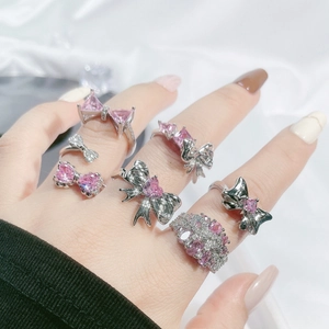Set of 6 sweet bow rings with pink zircon stones for women on white silk background