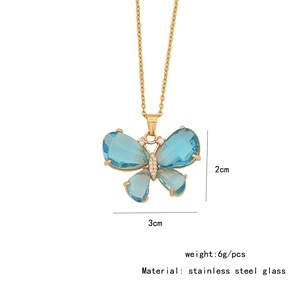Detailed close-up of blue butterfly pendant necklace with small crystals and glass inlay