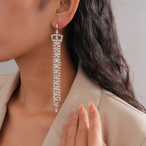 Close-up of elegant long tassel rhinestone earrings on model for a glamorous look