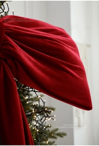 Close-up of premium red velvet bow texture with elegant folds for Christmas decor