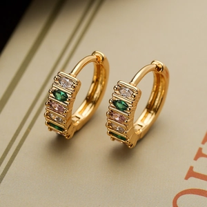 Detailed macro shot of gold plated hoop earrings with colorful multi-gemstone inlay