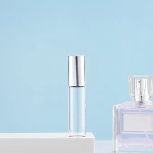 Detailed view of an empty 10ml glass roller bottle with a silver metal cap on white stand