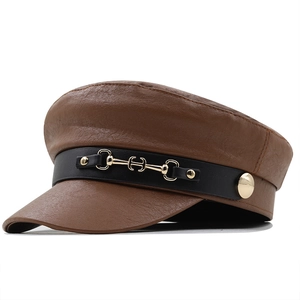 Vintage brown leather baker boy hat with horsebit metal buckle and flat top design