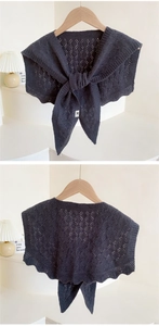 Front and back view of a dark grey knit shawl with hollow diamond patterns and ties