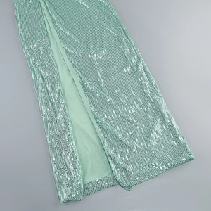 Detail of mint green sequin dress showing side slit and high-quality fabric texture