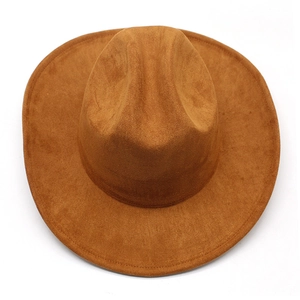Top-down macro view of brown faux suede western hat with wide brim and center crease