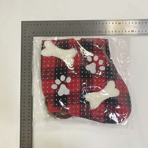Plaid pet outfit inside clear packaging shown with measuring rulers for accurate sizing