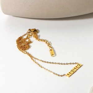 Detailed macro shot of 18K gold plated necklace with mama letter pendant and K18 hallmark