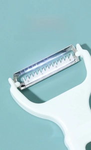 Macro shot of sharp stainless steel double blade and serrated teeth for vegetable peeling