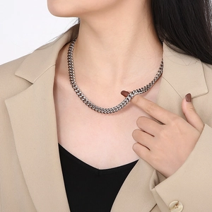 Classic silver stainless steel Cuban link chain necklace worn on a male model with a suit