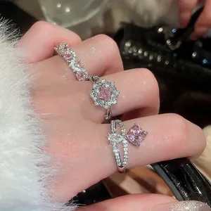 Adjustable sparkling pink zircon geometric ring set in silver on a plush background